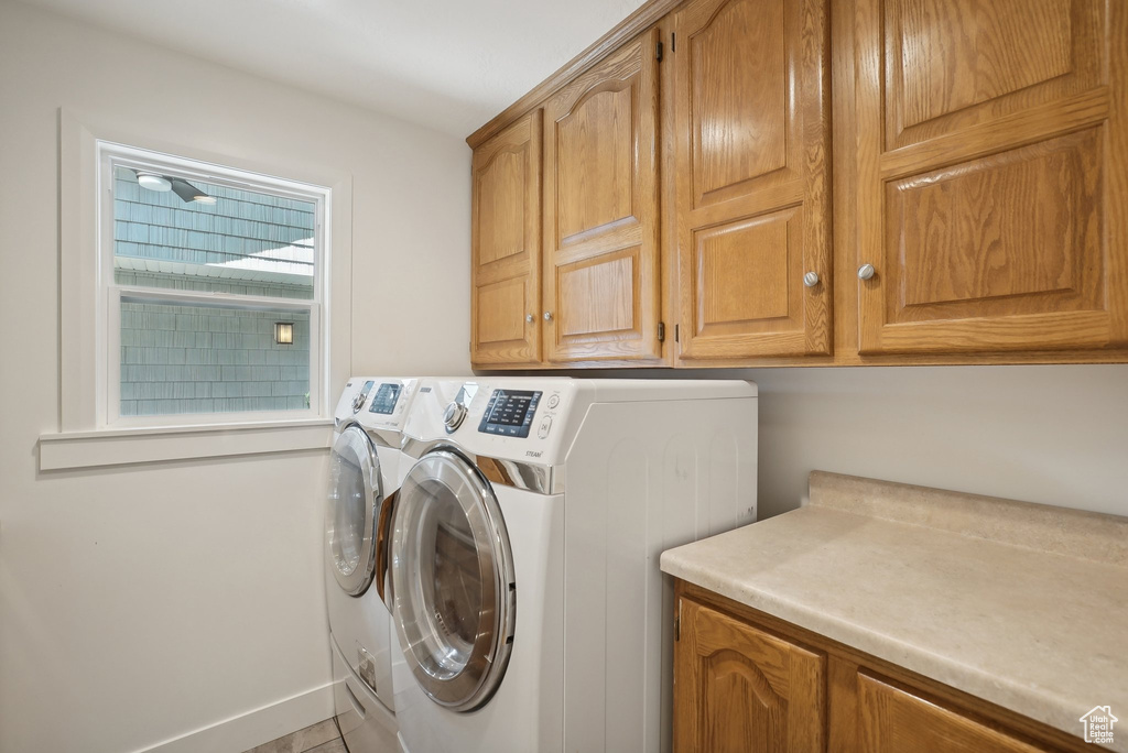 Clothes washing area with cabinets and independent washer and dryer