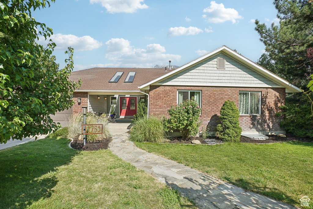 View of front of house with a front yard