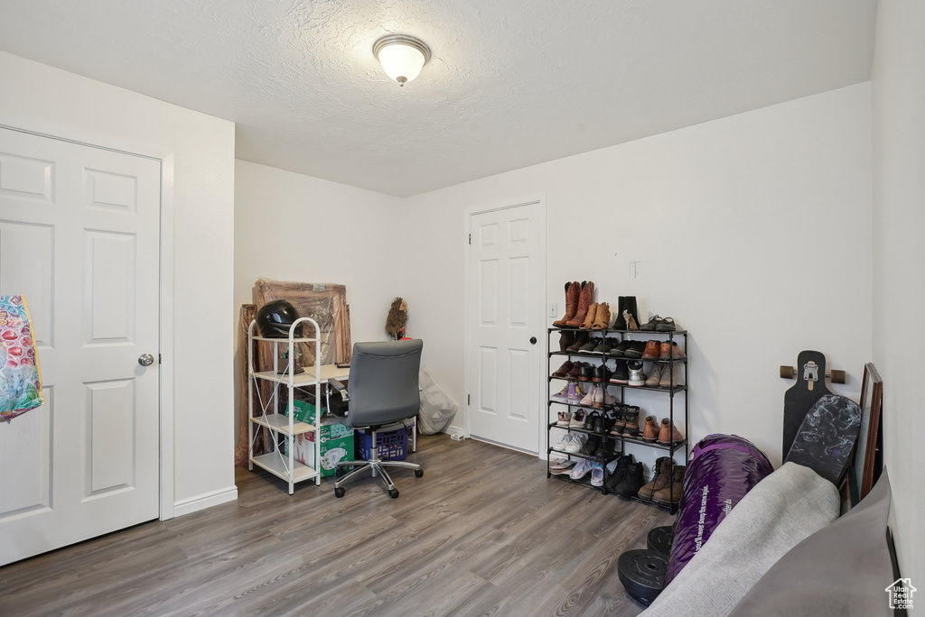 Office space featuring a textured ceiling and wood-type flooring