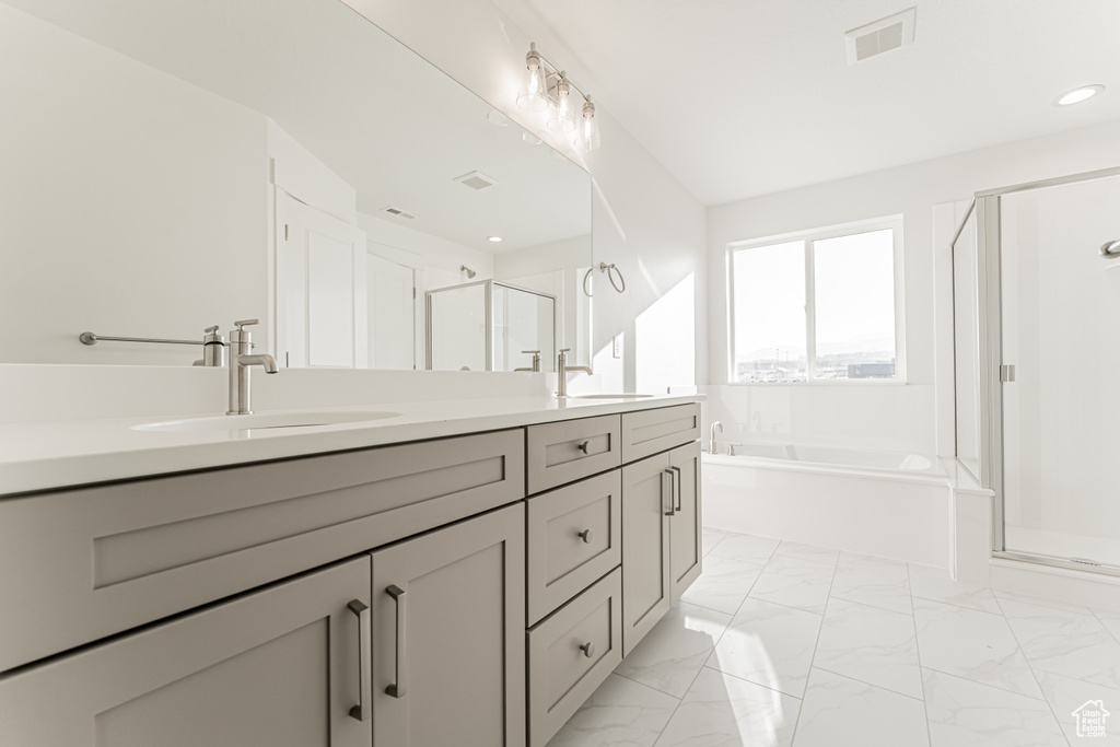 Bathroom with vanity and independent shower and bath