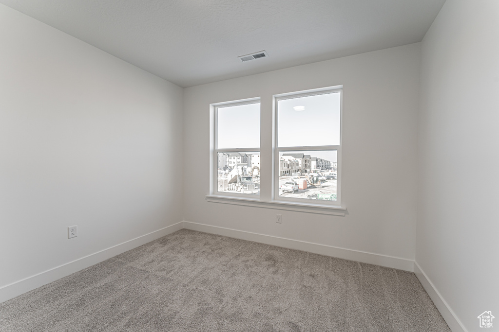 Empty room with light colored carpet