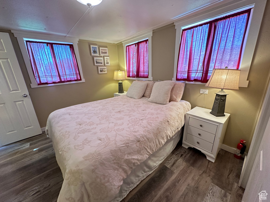 Bedroom featuring dark hardwood / wood-style flooring and ornamental molding