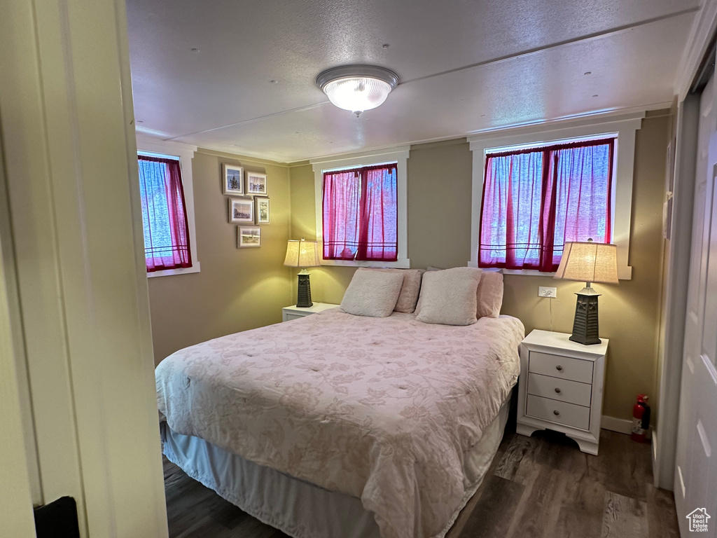 Bedroom with crown molding and dark hardwood / wood-style floors