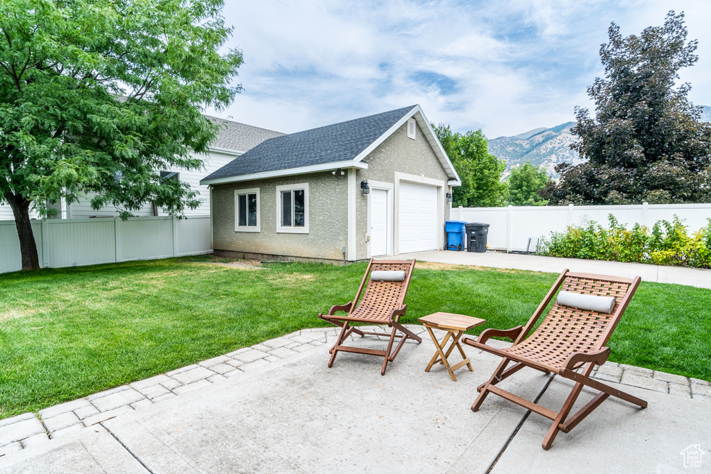 View of patio featuring a mountain view and a garage