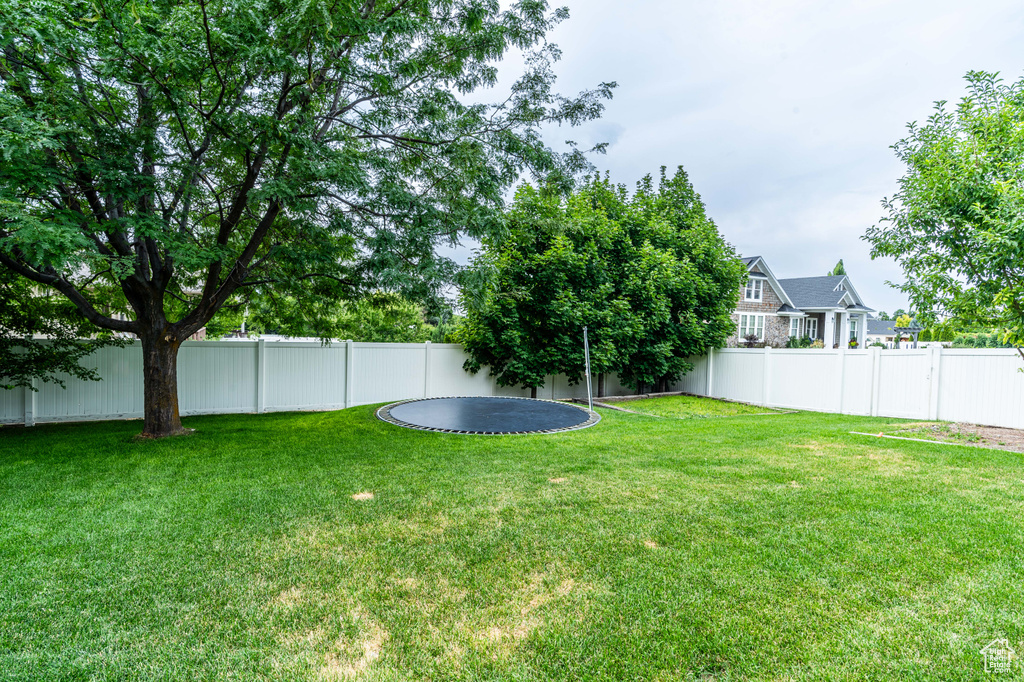 View of yard featuring a trampoline