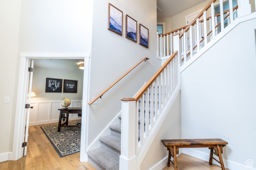 Staircase featuring light hardwood / wood-style floors