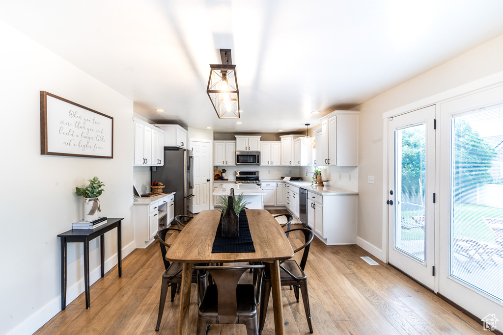 Dining area with light hardwood / wood-style floors