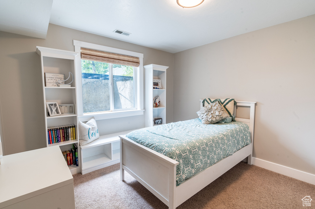 Bedroom with light colored carpet