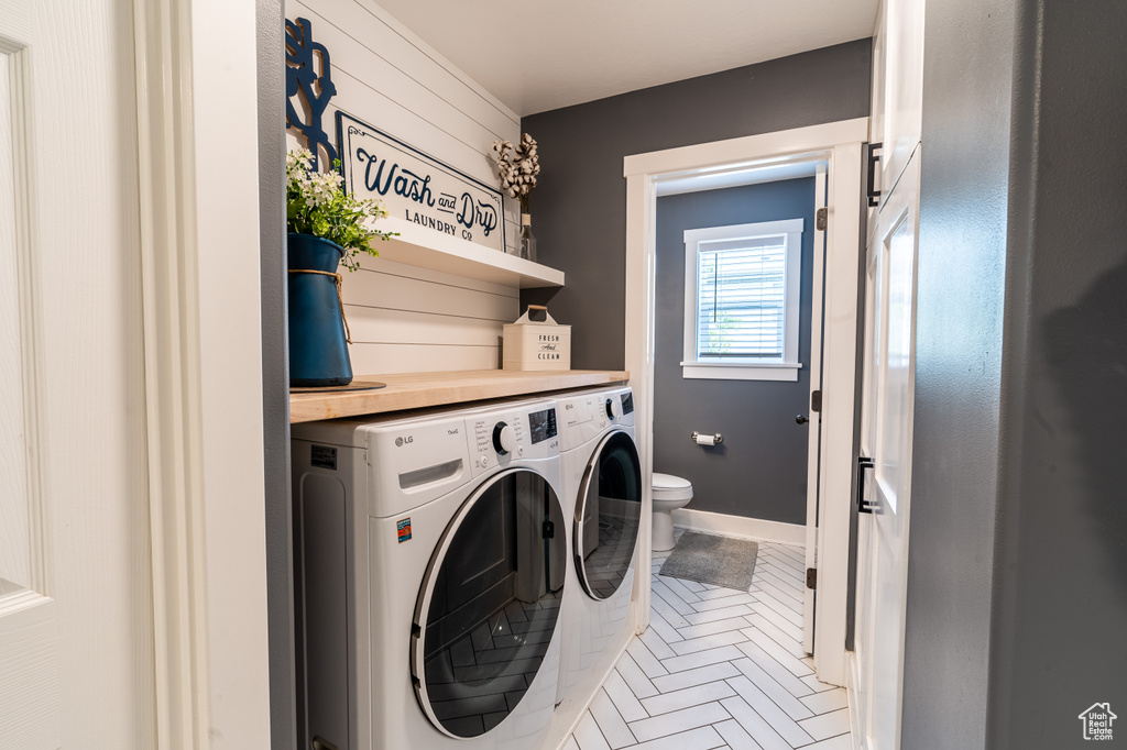 Clothes washing area featuring separate washer and dryer