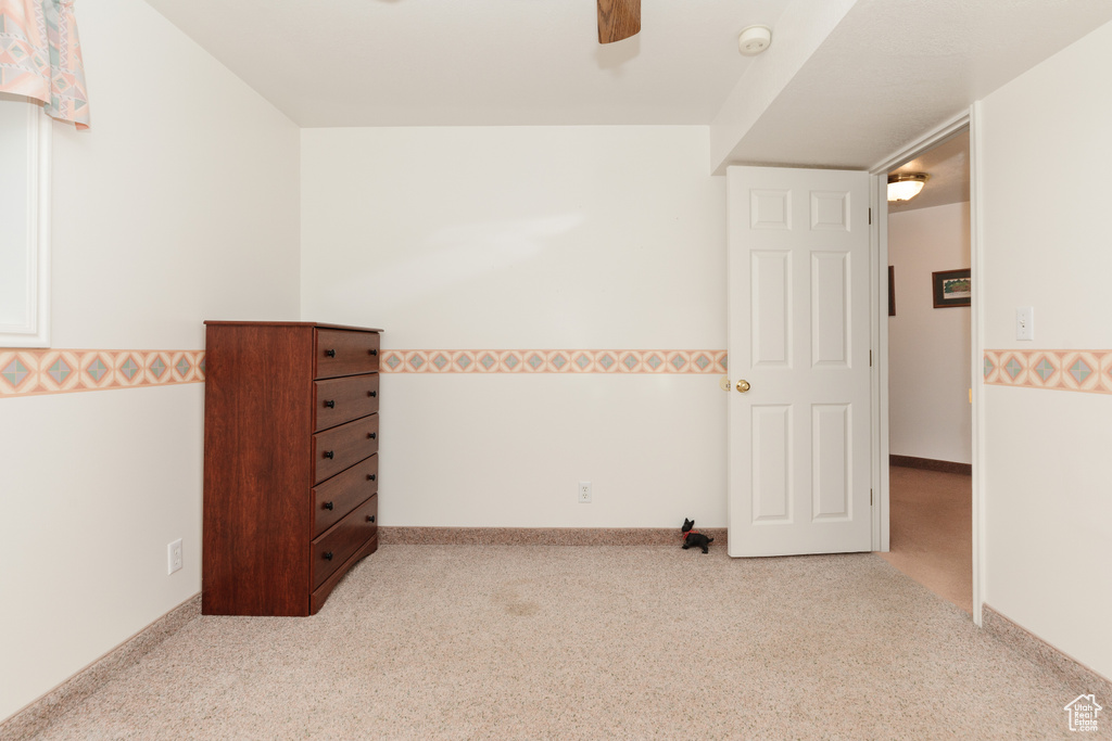 Unfurnished room featuring light carpet