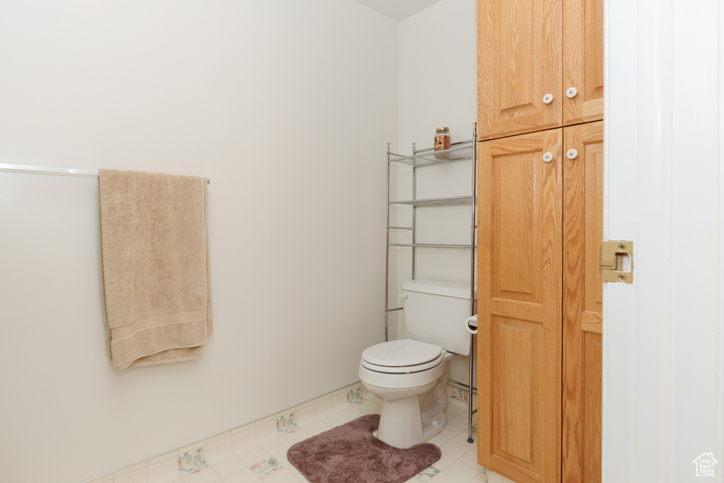 Bathroom featuring tile patterned flooring and toilet