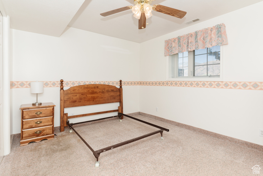 Carpeted bedroom with ceiling fan