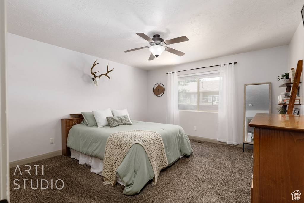 Carpeted bedroom with ceiling fan