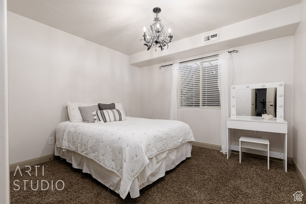 Bedroom featuring carpet and an inviting chandelier