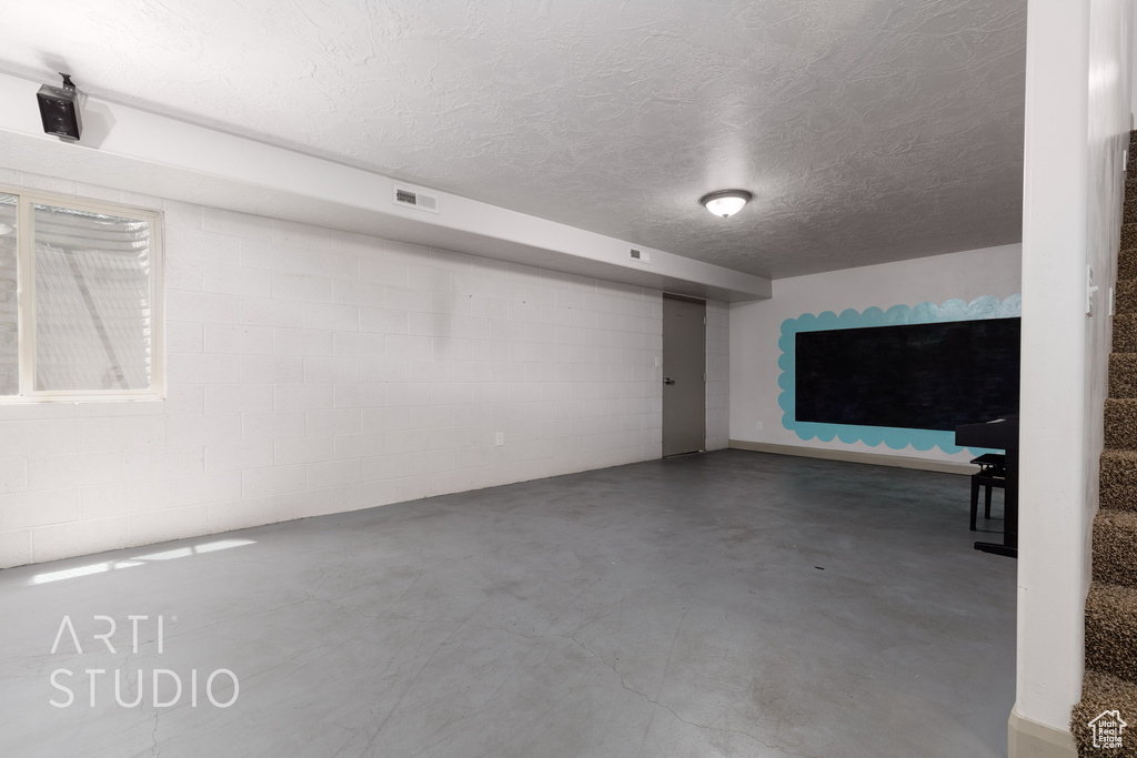 Basement featuring a textured ceiling