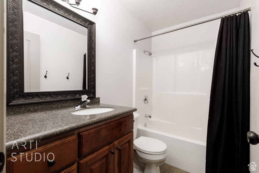 Full bathroom with shower / tub combo with curtain, vanity, and toilet