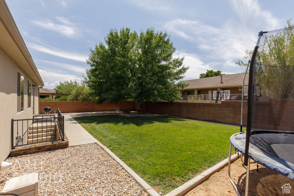 View of yard with a patio and a trampoline