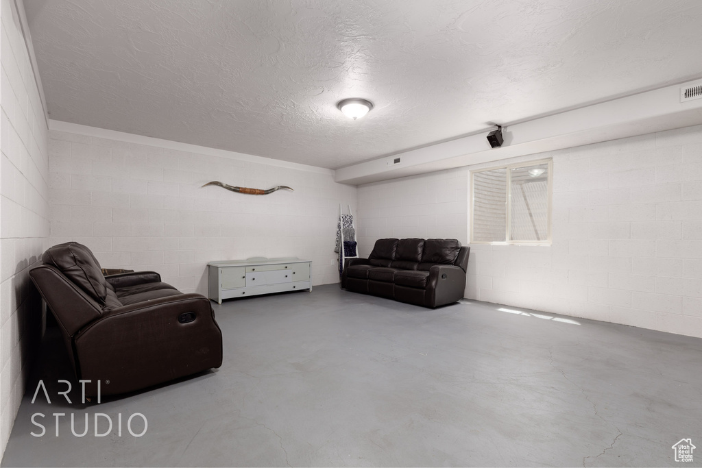 Living area with concrete floors and a textured ceiling