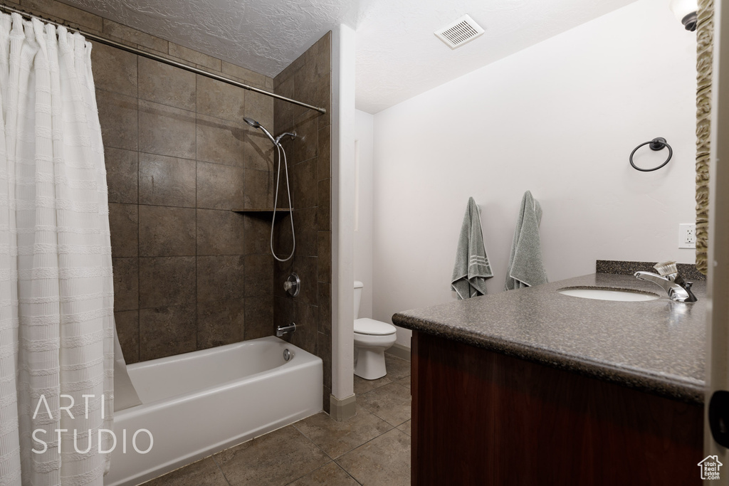 Full bathroom with vanity, tile patterned flooring, toilet, and shower / bath combination with curtain