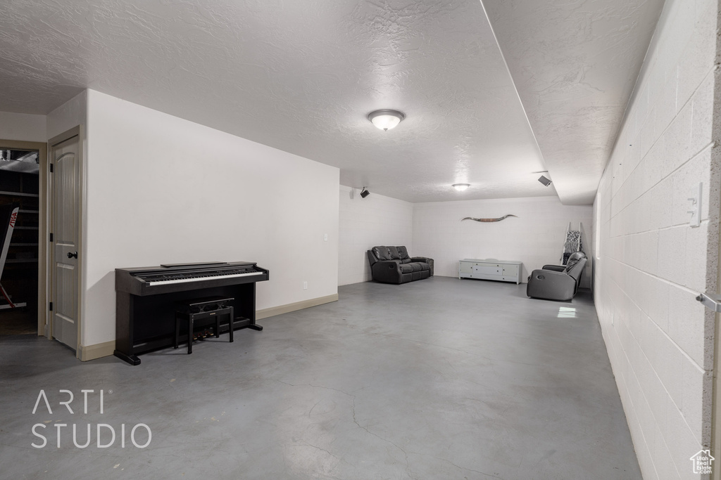 Basement featuring a textured ceiling