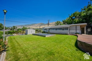 View of yard featuring a storage unit