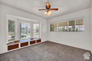 Empty room with carpet floors and ceiling fan