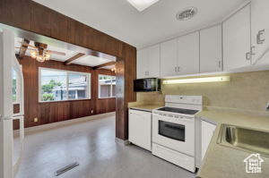 Kitchen with white appliances and white cabinets