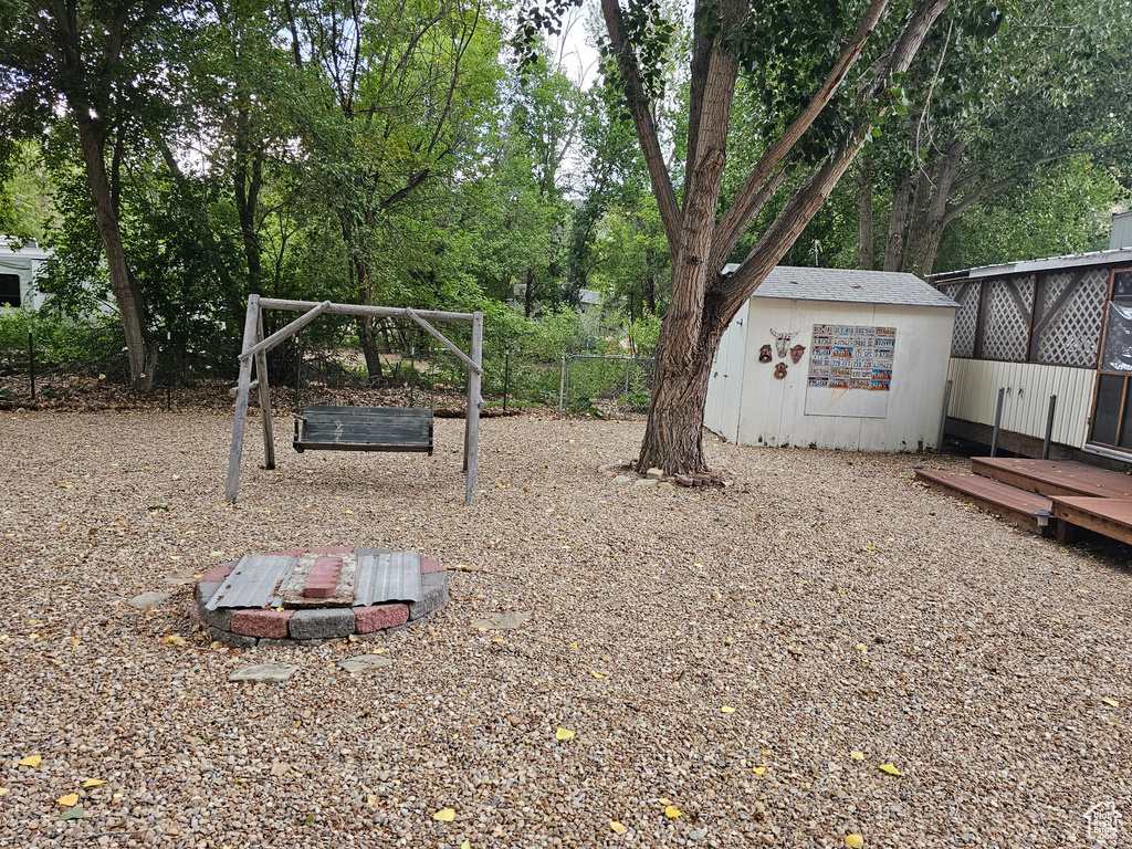 View of yard with a deck and an outdoor structure