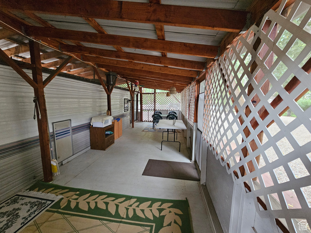 Unfurnished sunroom featuring vaulted ceiling