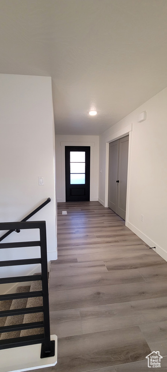 Hall with hardwood / wood-style floors