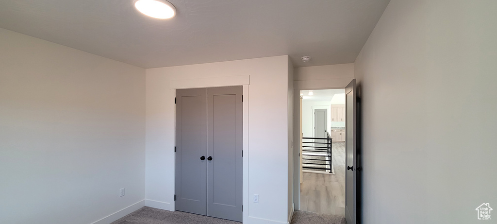 Unfurnished bedroom with a closet and carpet floors