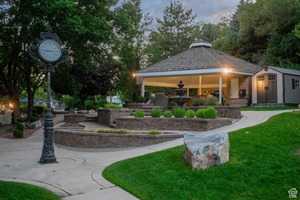 View of home\\\'s community featuring a yard, an outbuilding, and a gazebo