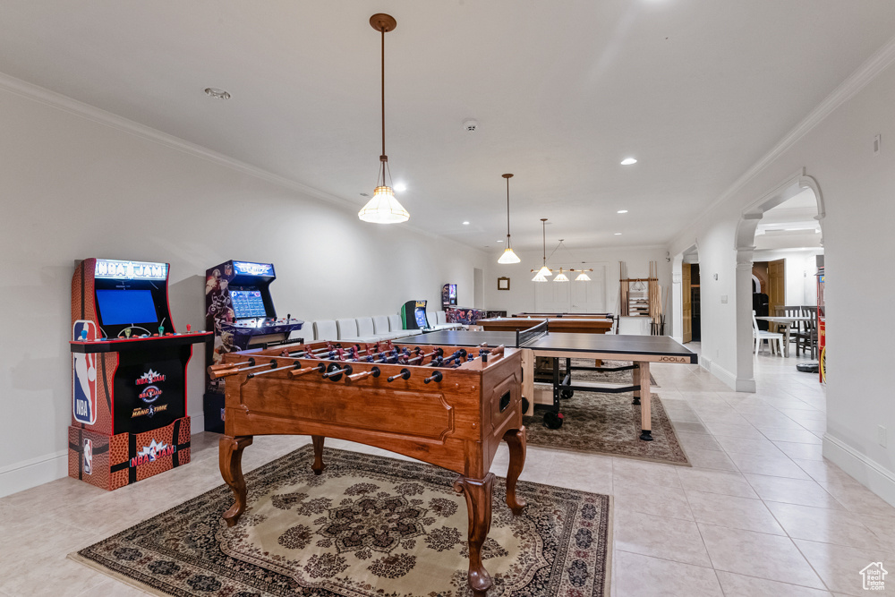 Playroom featuring light tile patterned floors and crown molding