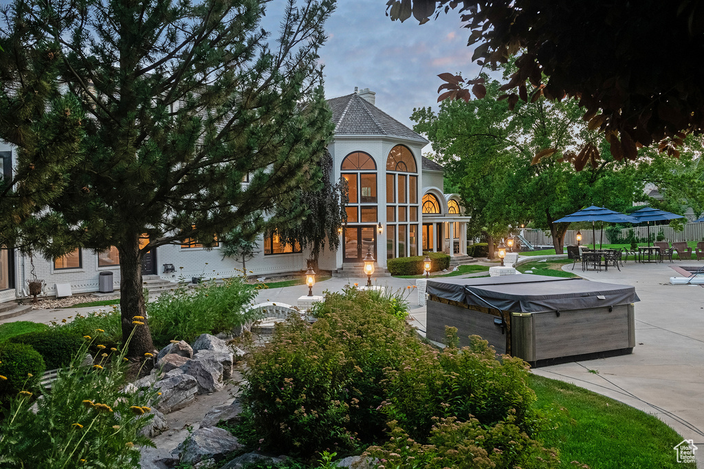 Exterior space featuring a patio area and a hot tub