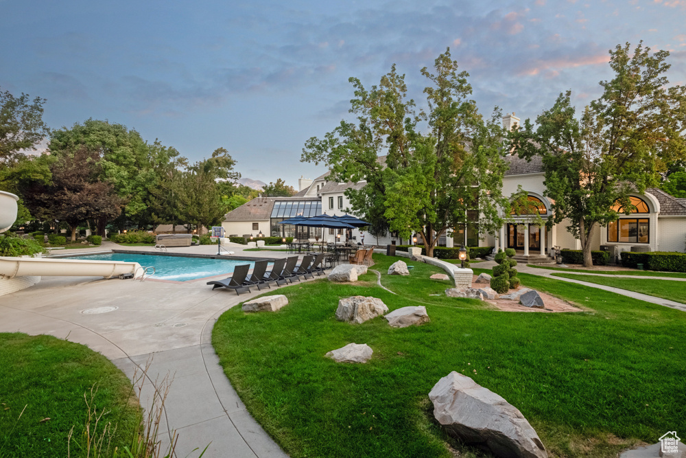 Pool at dusk with a lawn