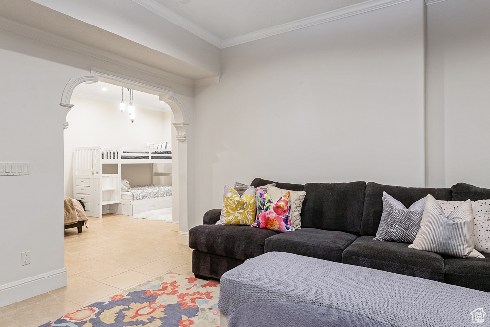 Living room featuring light tile patterned flooring and ornamental molding