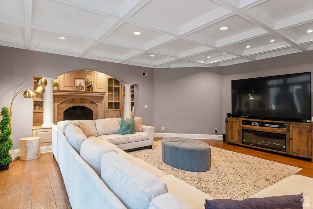 Living room featuring beamed ceiling, light hardwood / wood-style floors, and coffered ceiling