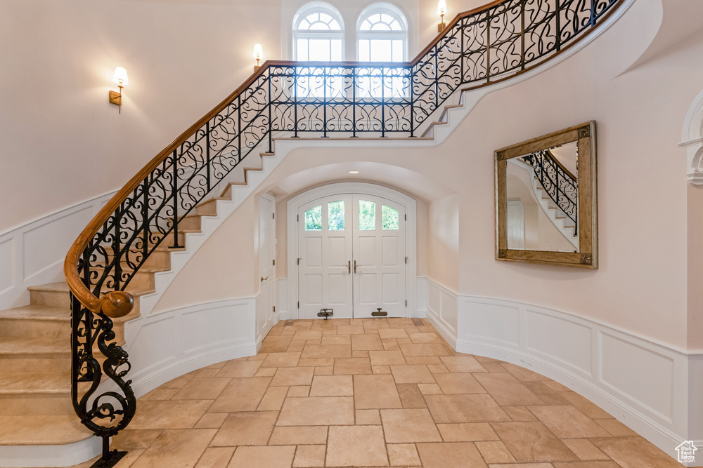 Foyer featuring tile patterned flooring and a high ceiling