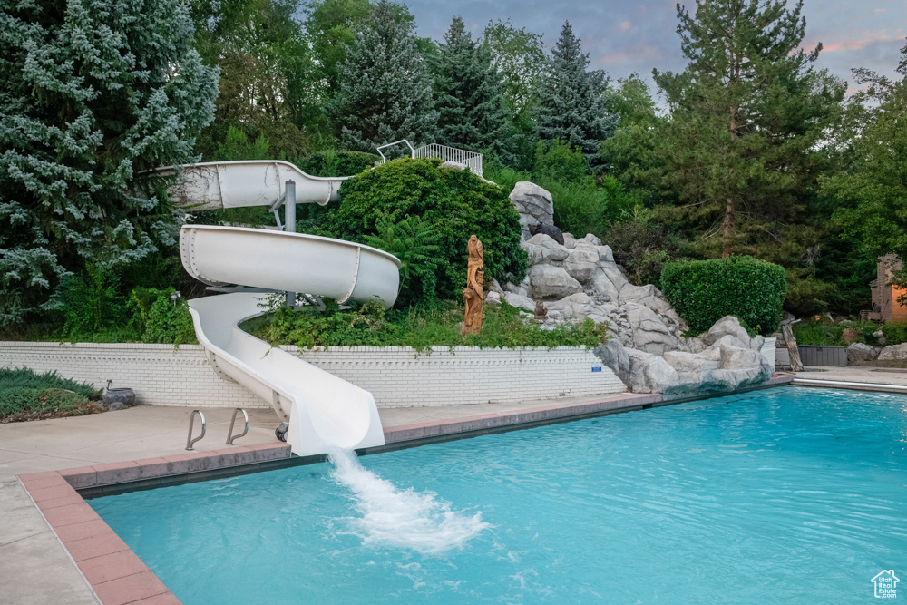 View of pool featuring a patio and a water slide