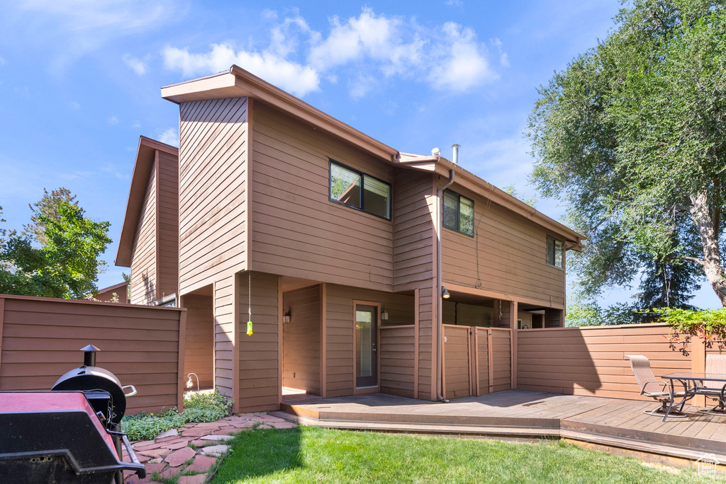 Back of property featuring a wooden deck