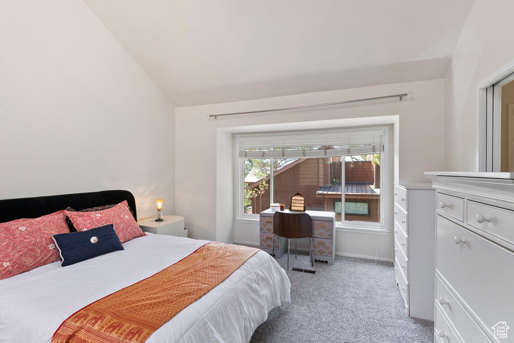 Carpeted bedroom with vaulted ceiling