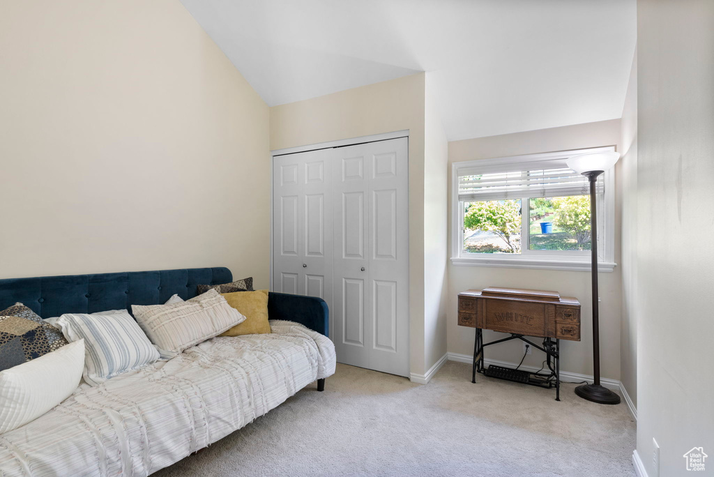 Interior space featuring lofted ceiling and light colored carpet