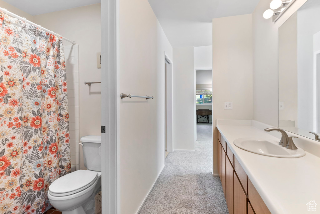 Bathroom featuring vanity and toilet