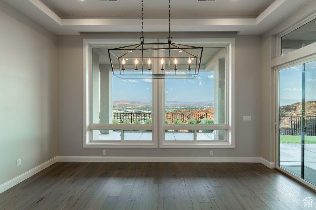 Unfurnished dining area with hardwood / wood-style floors and a wealth of natural light