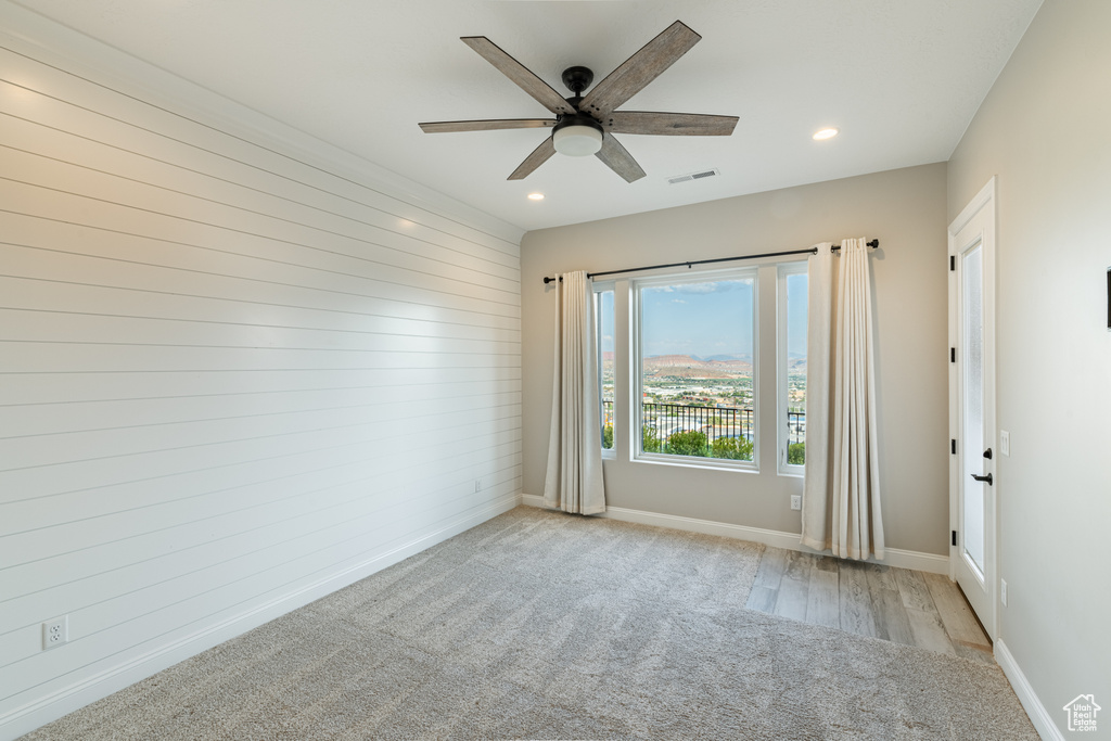 Spare room featuring ceiling fan and light colored carpet