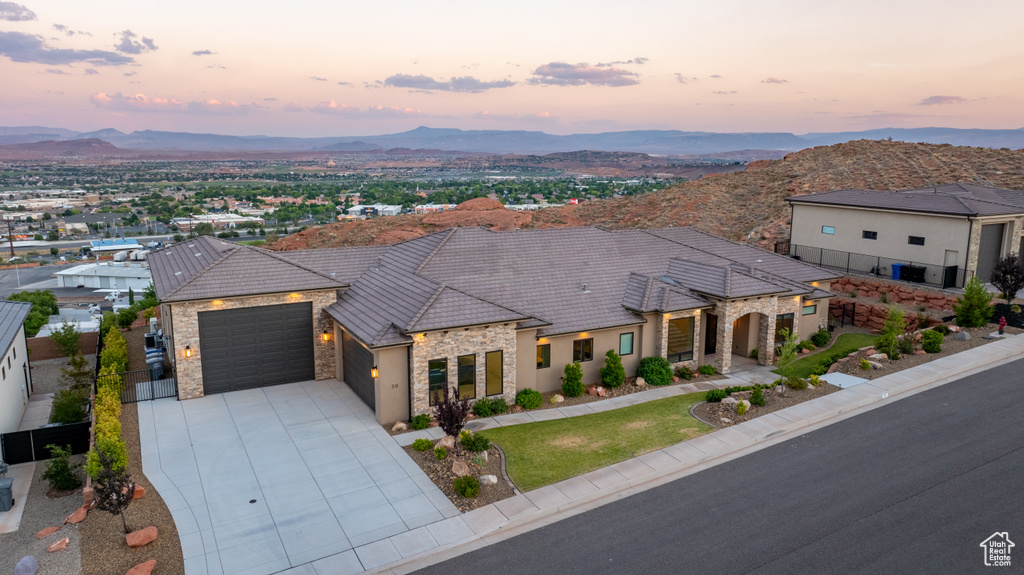 View of front facade featuring a mountain view and a garage