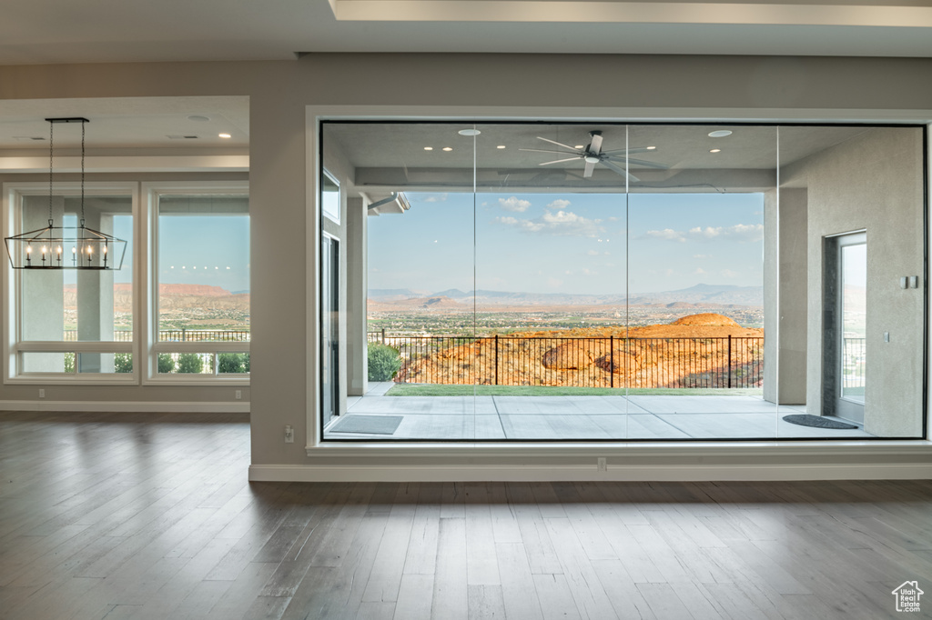 Details with a mountain view, a notable chandelier, and hardwood / wood-style floors