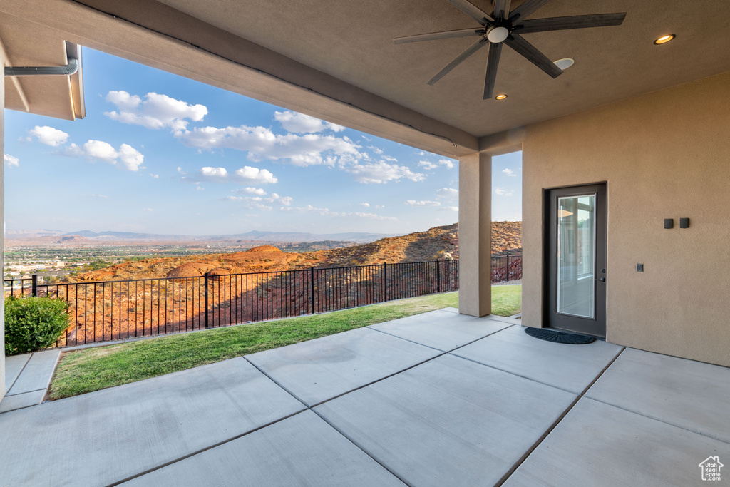 View of patio featuring ceiling fan and a mountain view