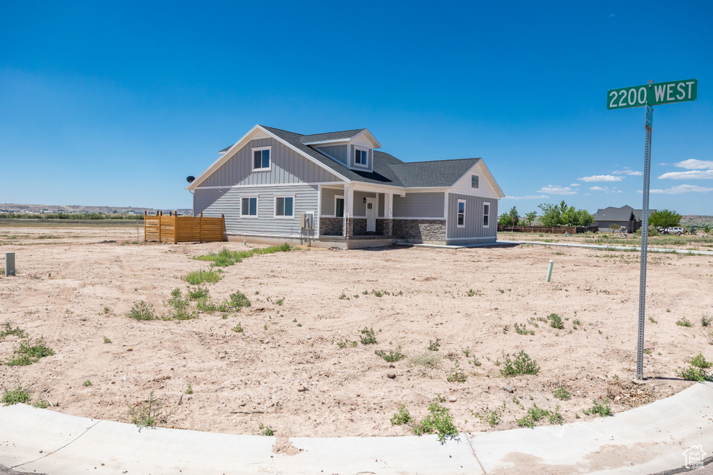 View of front of home featuring board and batten siding and covered porch