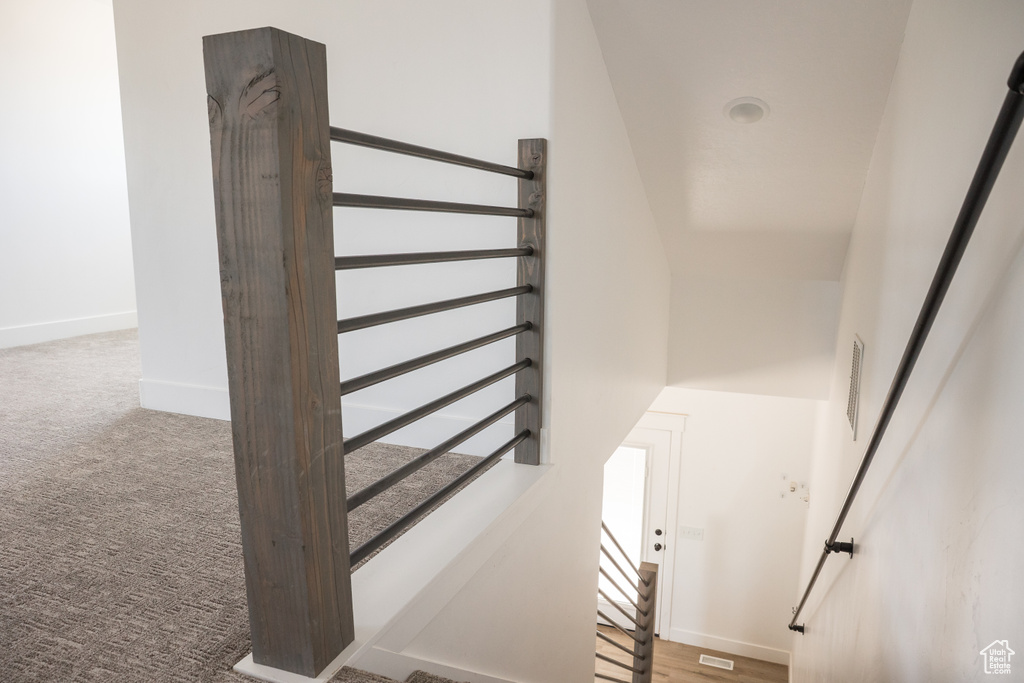 Stairway with baseboards and carpet